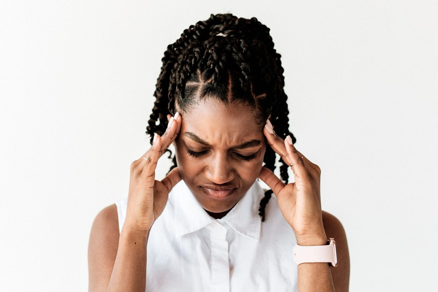 Woman experiencing tension and anxiety, holding her temples